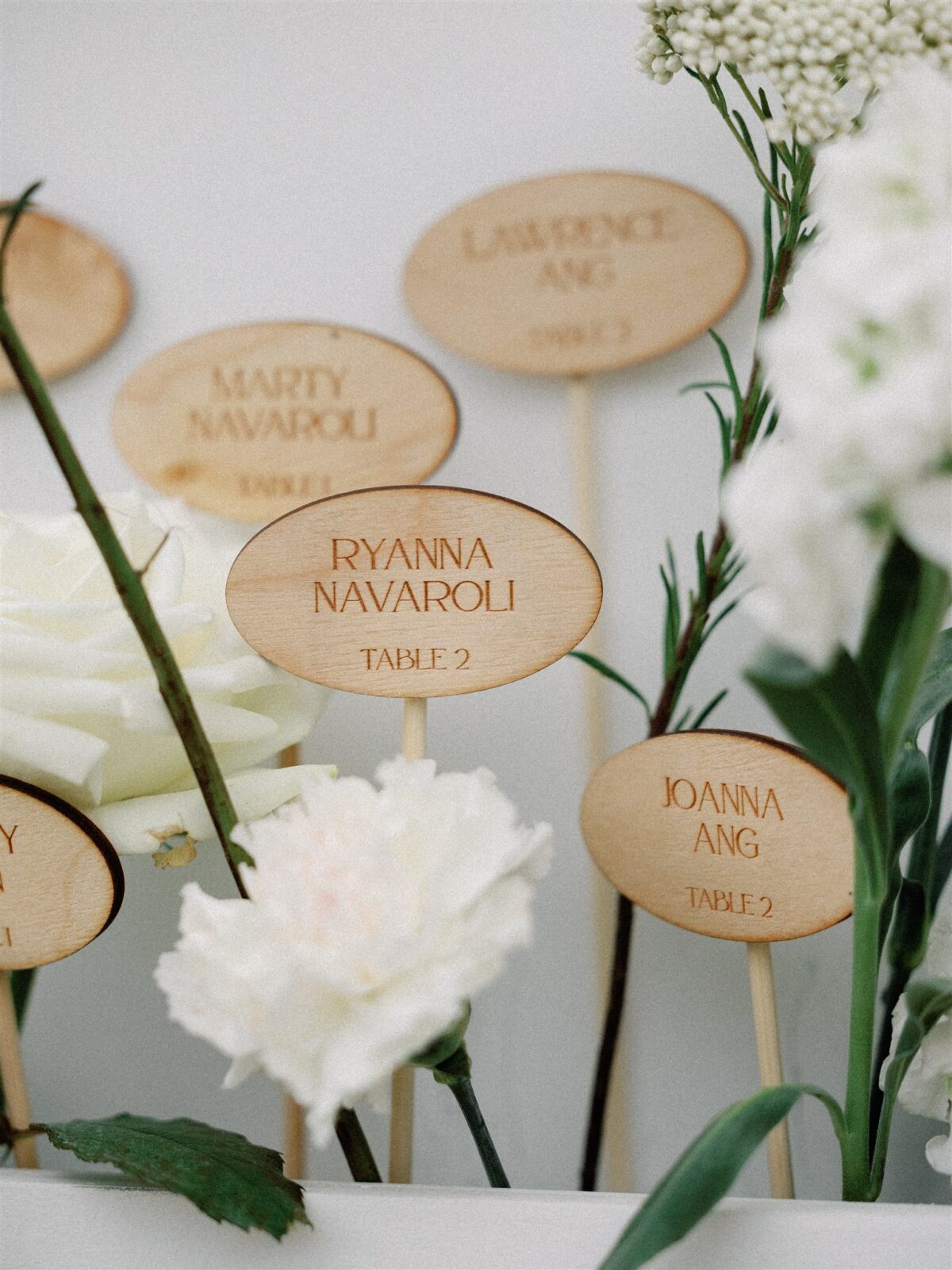 Wooden escort cards on a large wedding seating chart