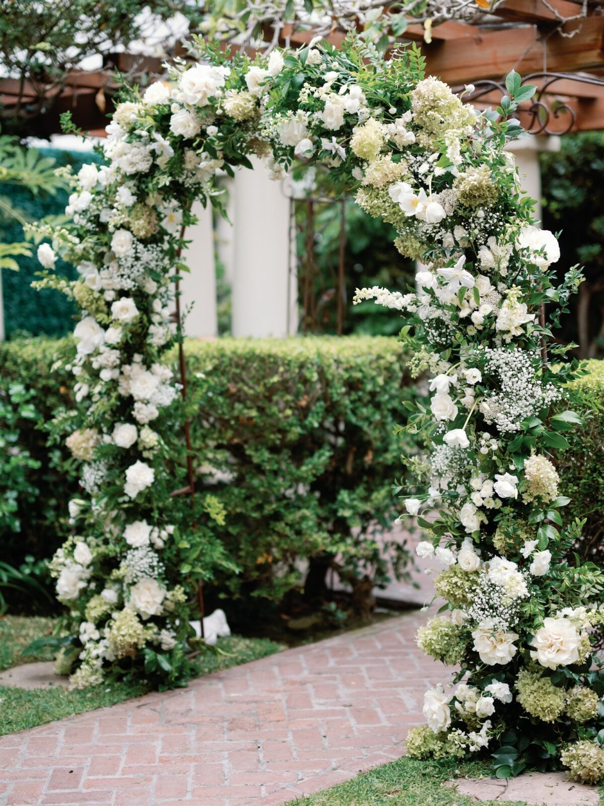 green and white modern ceremony floral arch at La Jolla Women's Club