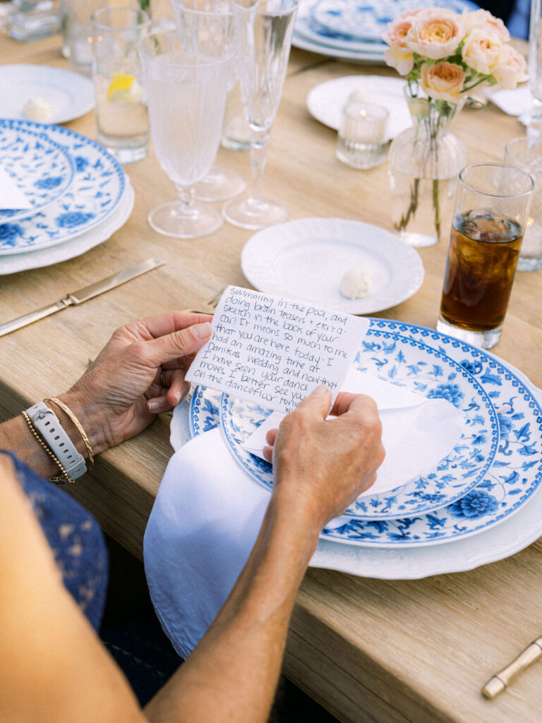 Wedding guest reading a hand written note