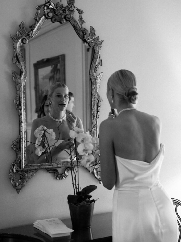 bride putting on lipstick at the Darlington House