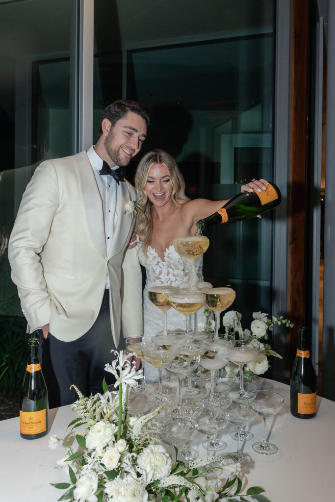 Bride and Groom pouring champagne into champagne tower