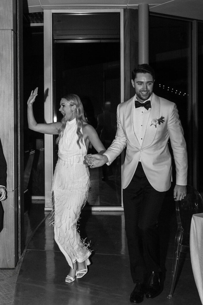 Bride and groom grand entrance to wedding at Scripps Seaside Forum