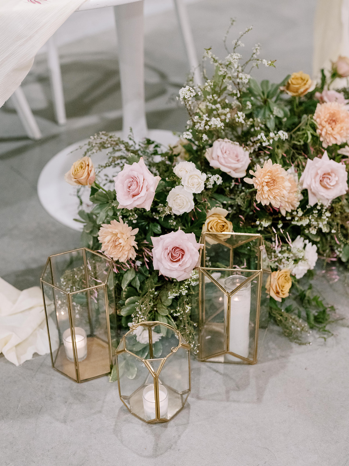 Large floral arrangement set at the bottom of a sweetheart table